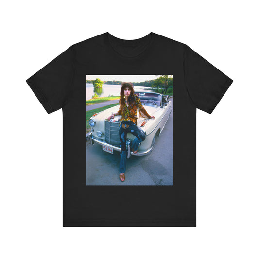 A black graphic t-shirt featuring a retro 70s photo of Aerosmith band members in a bohemian style, posing with a classic Mercedes car.