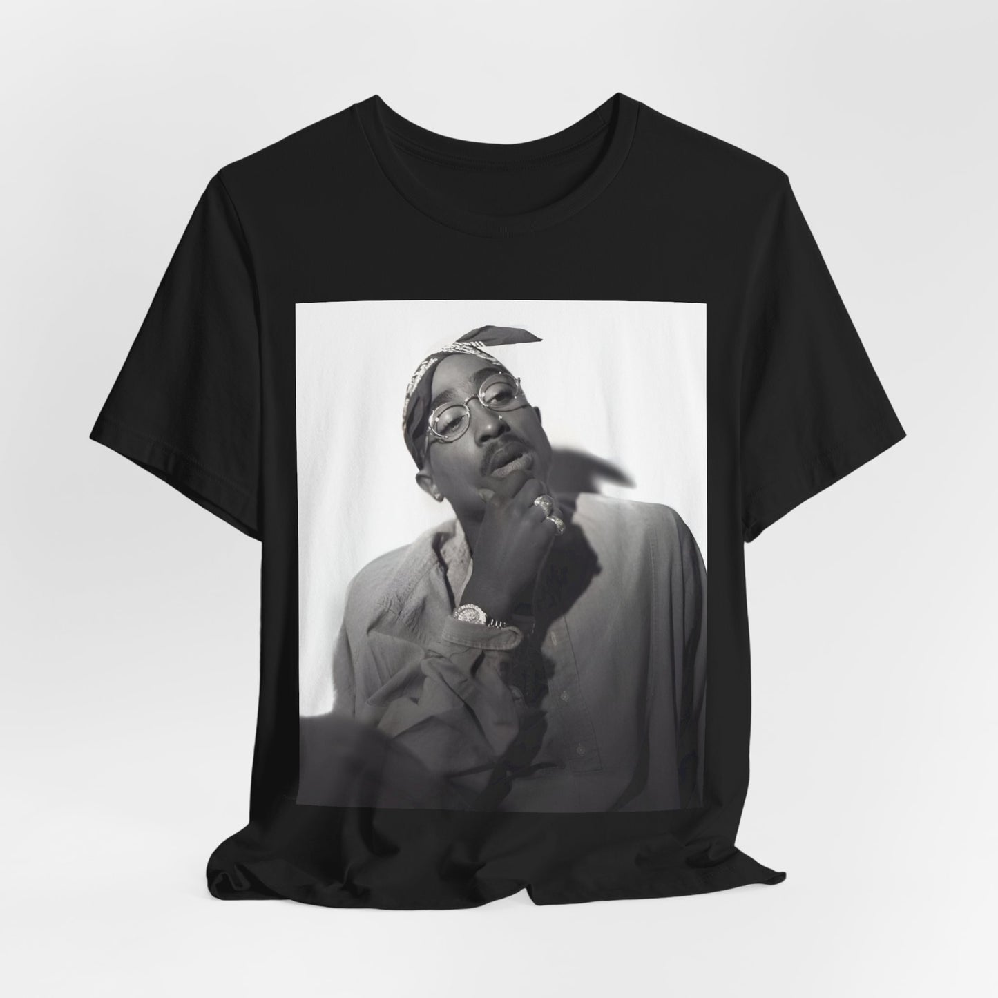 A black graphic t-shirt featuring a classic 90s West Coast rap graphic of Tupac.