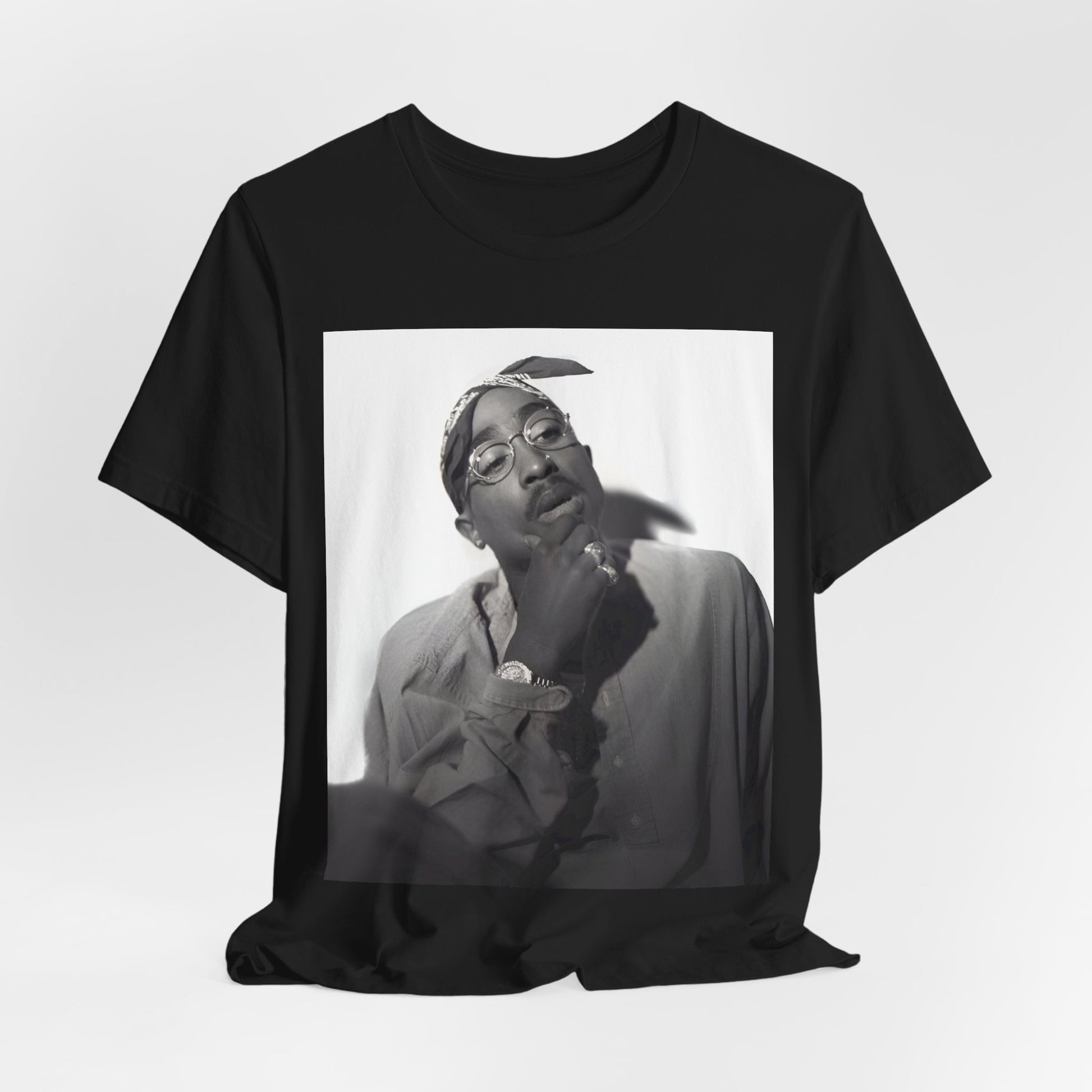 A black graphic t-shirt featuring a classic 90s West Coast rap graphic of Tupac.