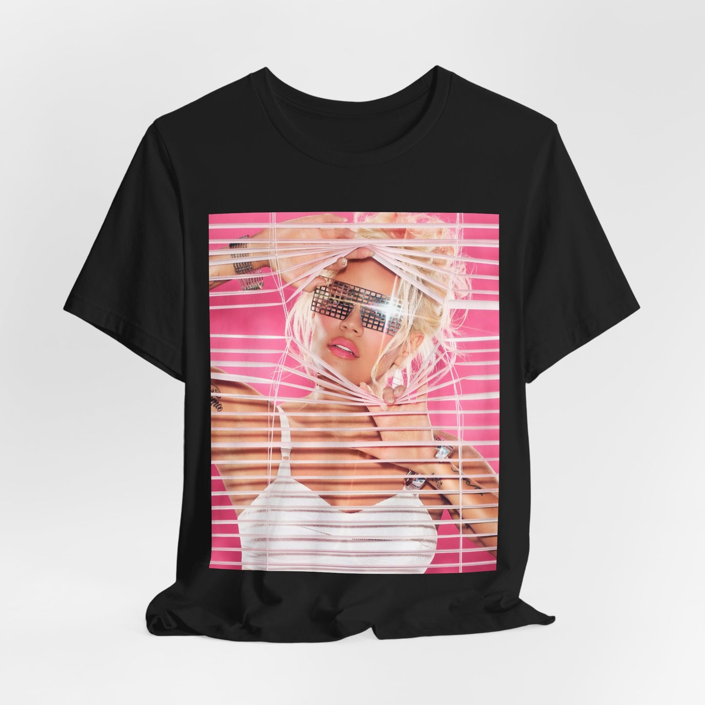 A black graphic t-shirt featuring a graphic of Karol G in a cool Latin trap style.