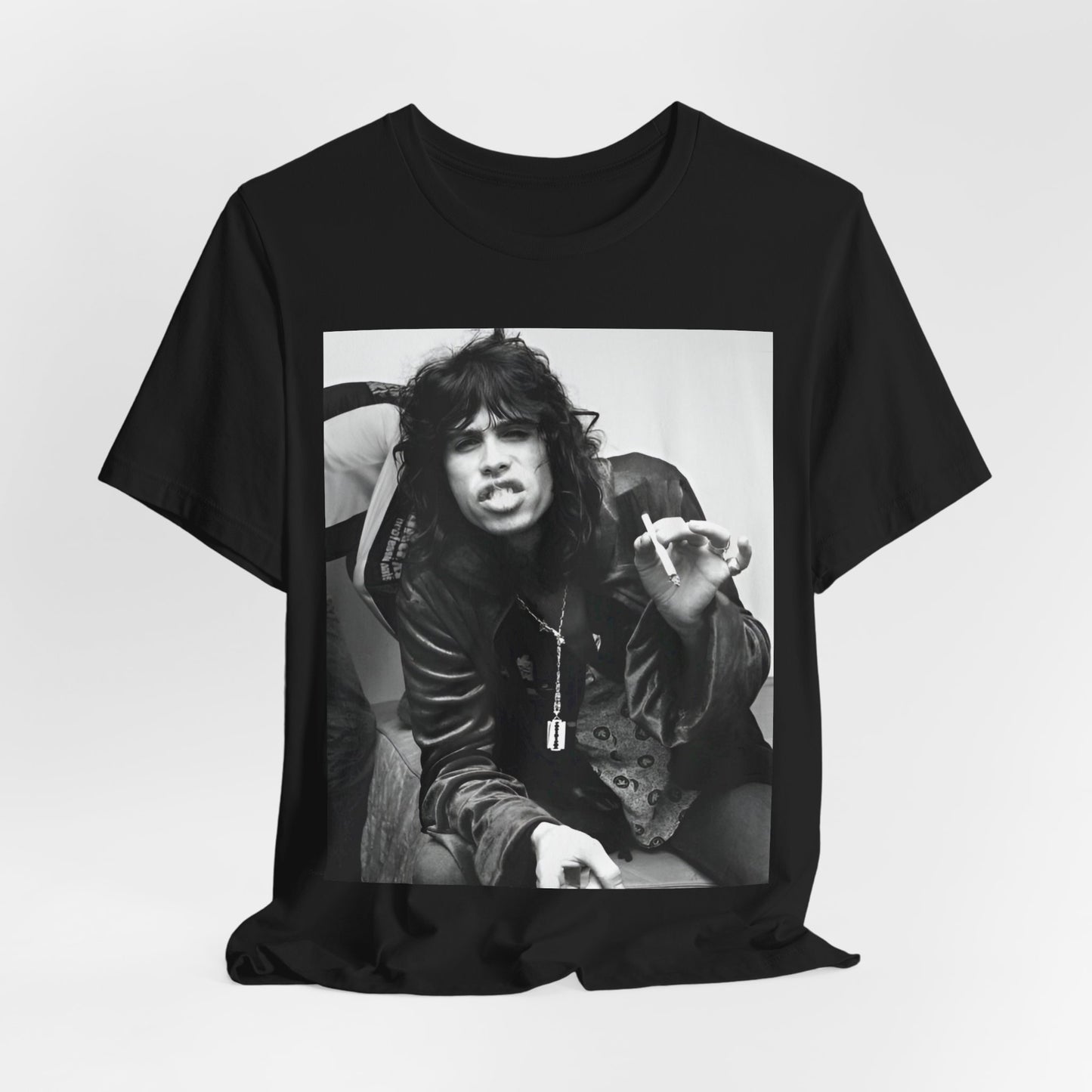 A black graphic t-shirt featuring a retro 70s photo of Aerosmith band members lounging in leather, exuding a cool, classic rock vibe.