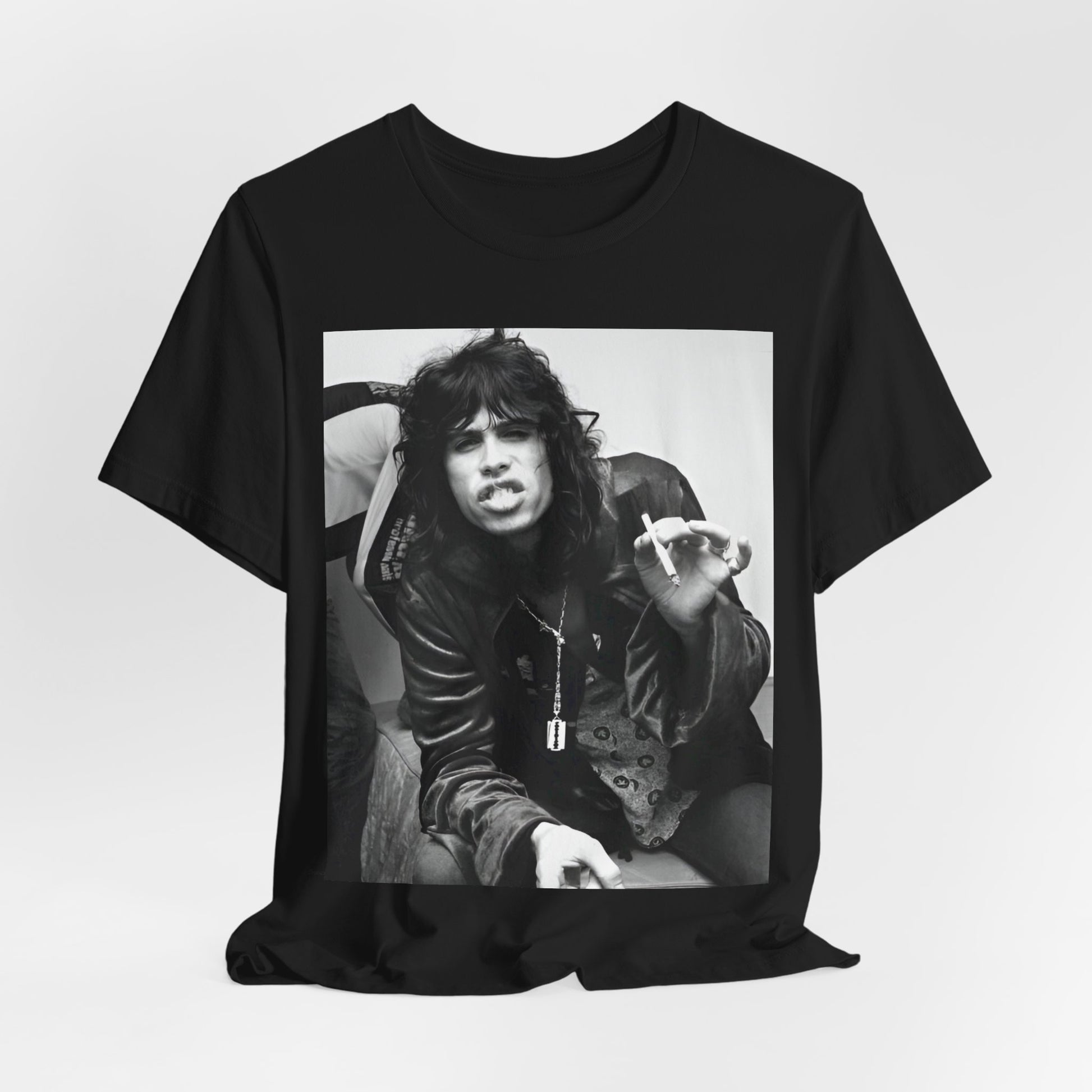 A black graphic t-shirt featuring a retro 70s photo of Aerosmith band members lounging in leather, exuding a cool, classic rock vibe.
