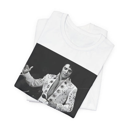 A black graphic t-shirt featuring a stylized graphic of Elvis Presley as The King of Rock 'n' Roll.