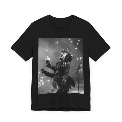 A black graphic t-shirt featuring a glamorous graphic or photo of Harry Styles performing on stage.
