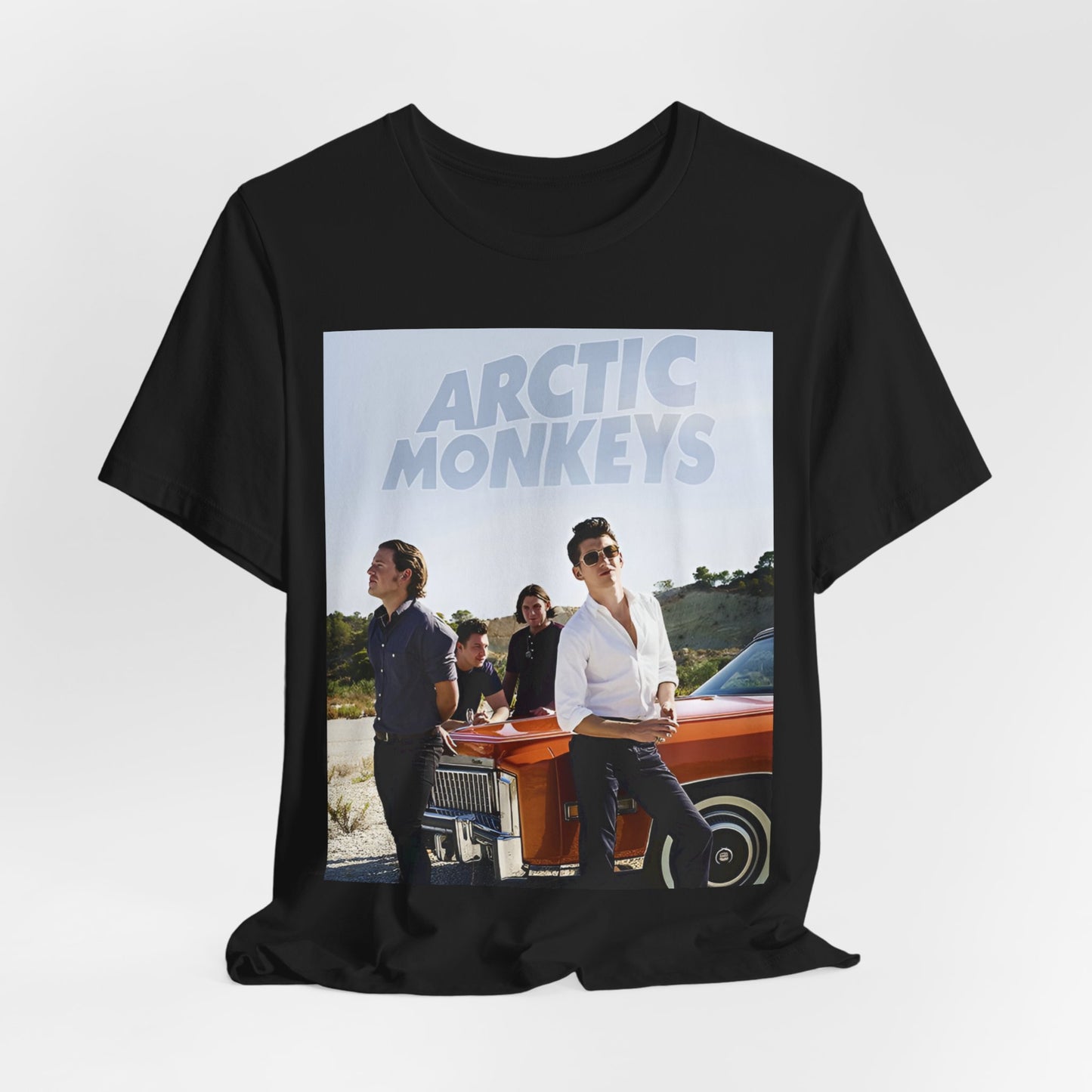 A black graphic t-shirt featuring a design related to Arctic Monkeys' 'AM' album era, possibly with the album art or band imagery.