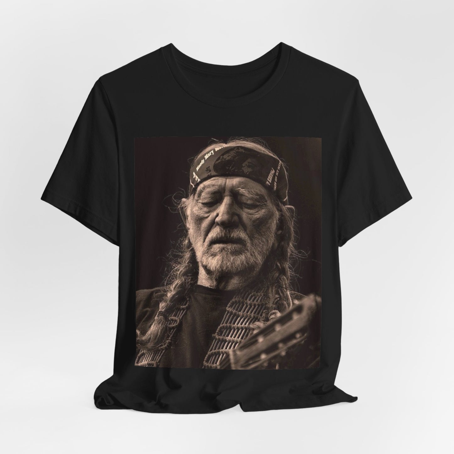 A black graphic t-shirt featuring a graphic of Willie Nelson with his iconic braids style.