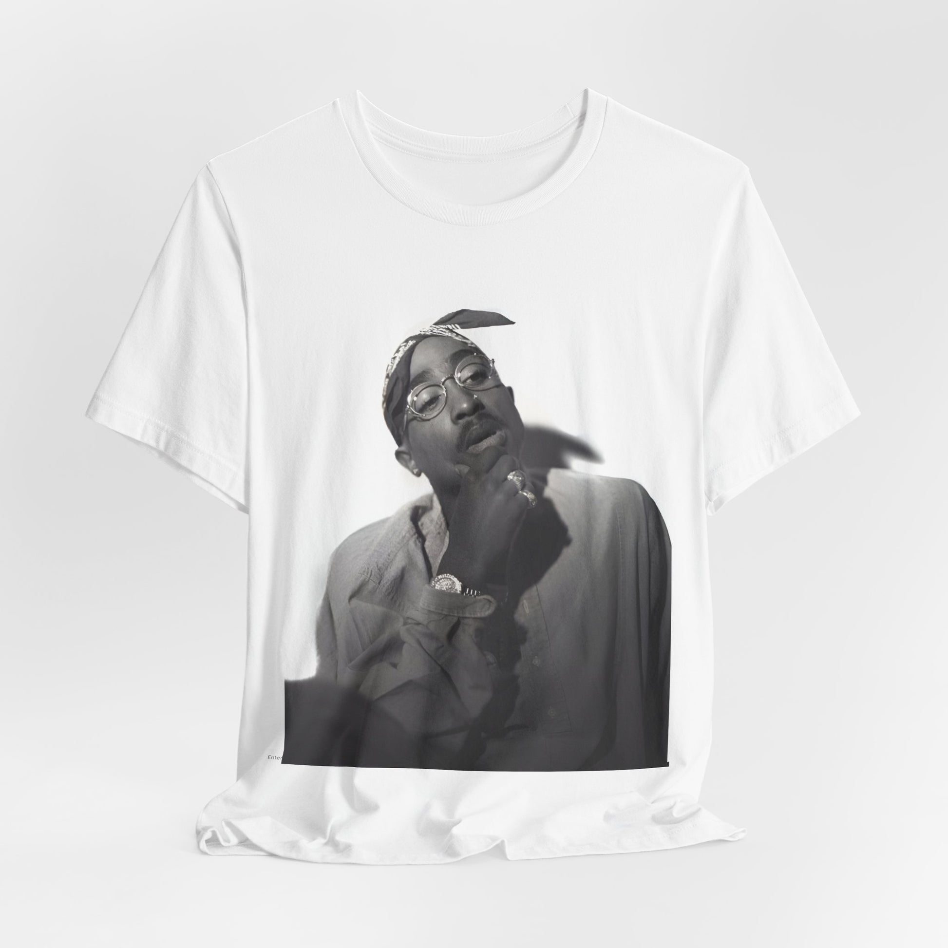 A black graphic t-shirt featuring a classic 90s West Coast rap graphic of Tupac.