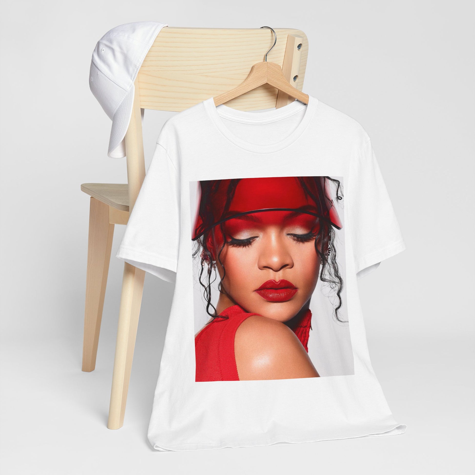 A black graphic t-shirt featuring a casual pop fan graphic of Rihanna.