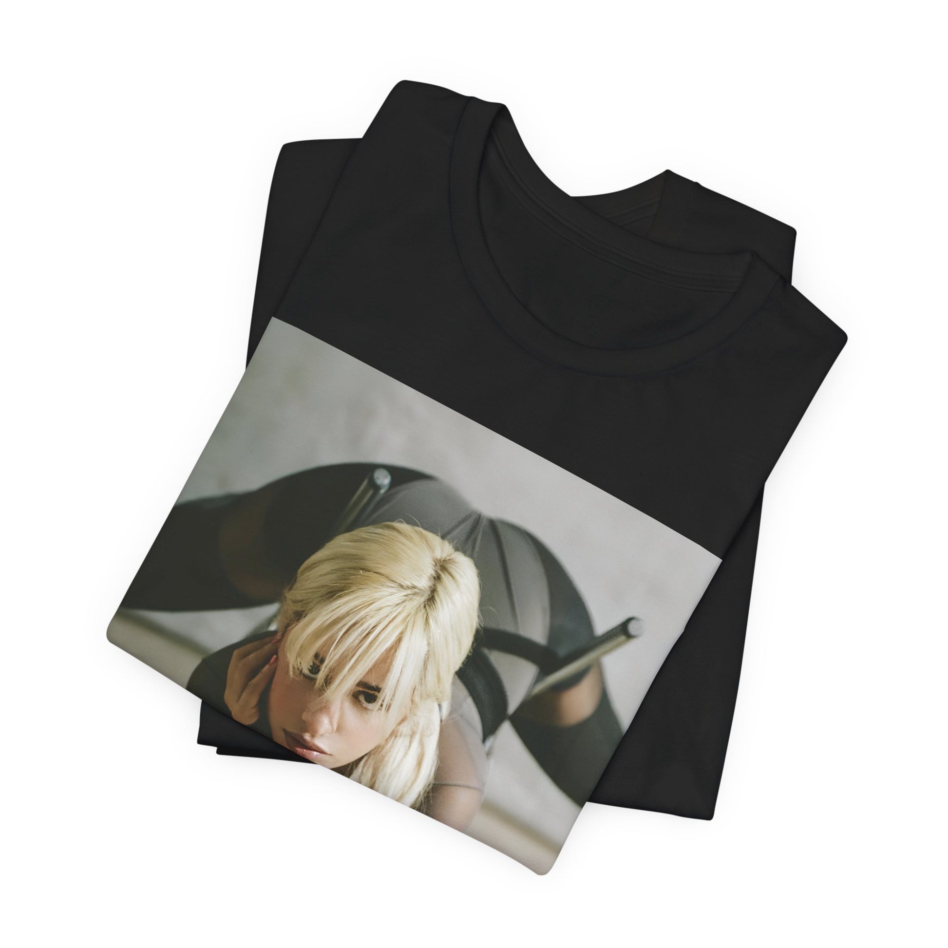 A black graphic t-shirt featuring a vintage-style graphic of Camila Cabello, possibly with a crown or 'Pop Queen' title.