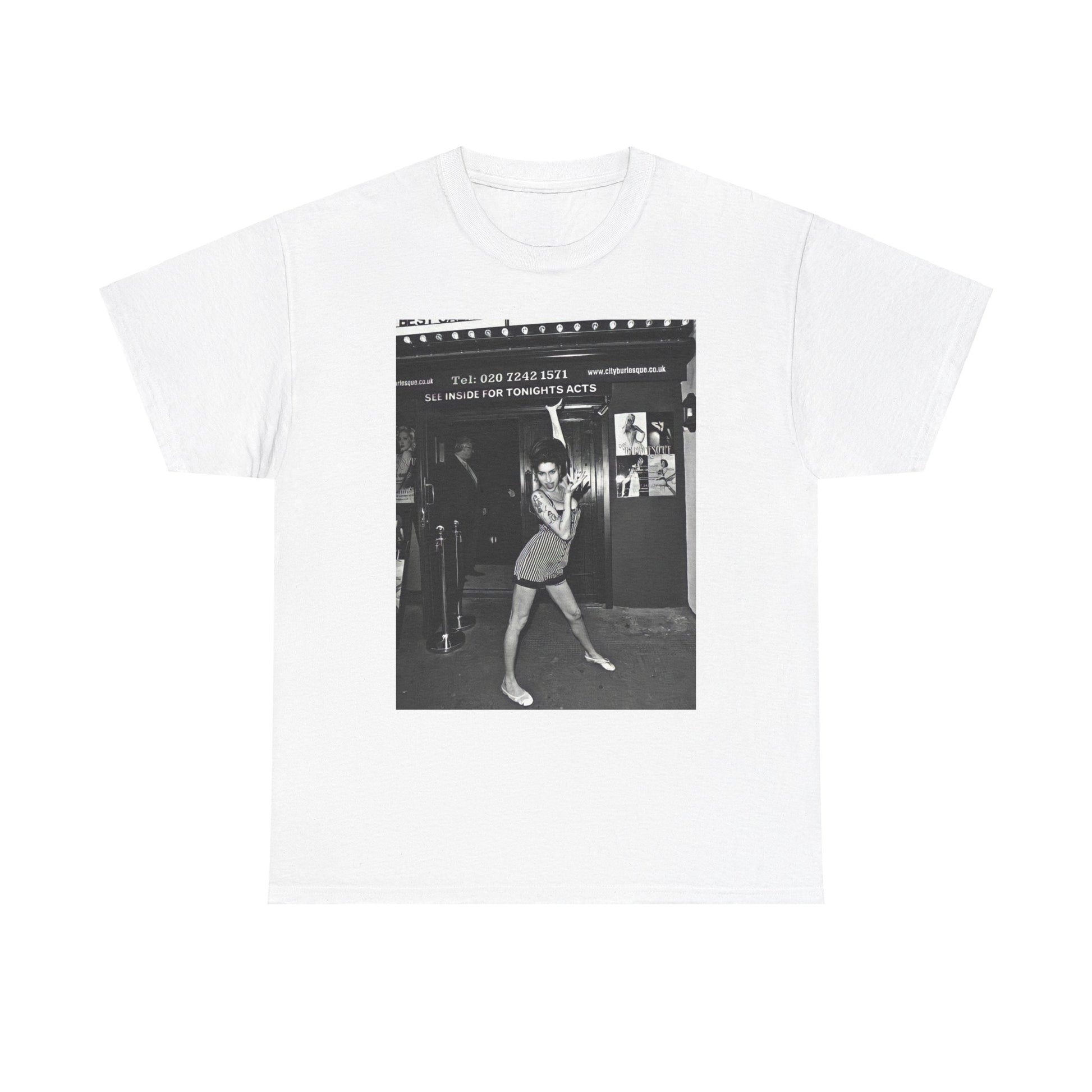 A black graphic t-shirt featuring a black and white graphic of Amy Winehouse in a burlesque club setting, stylized to evoke that ambiance.