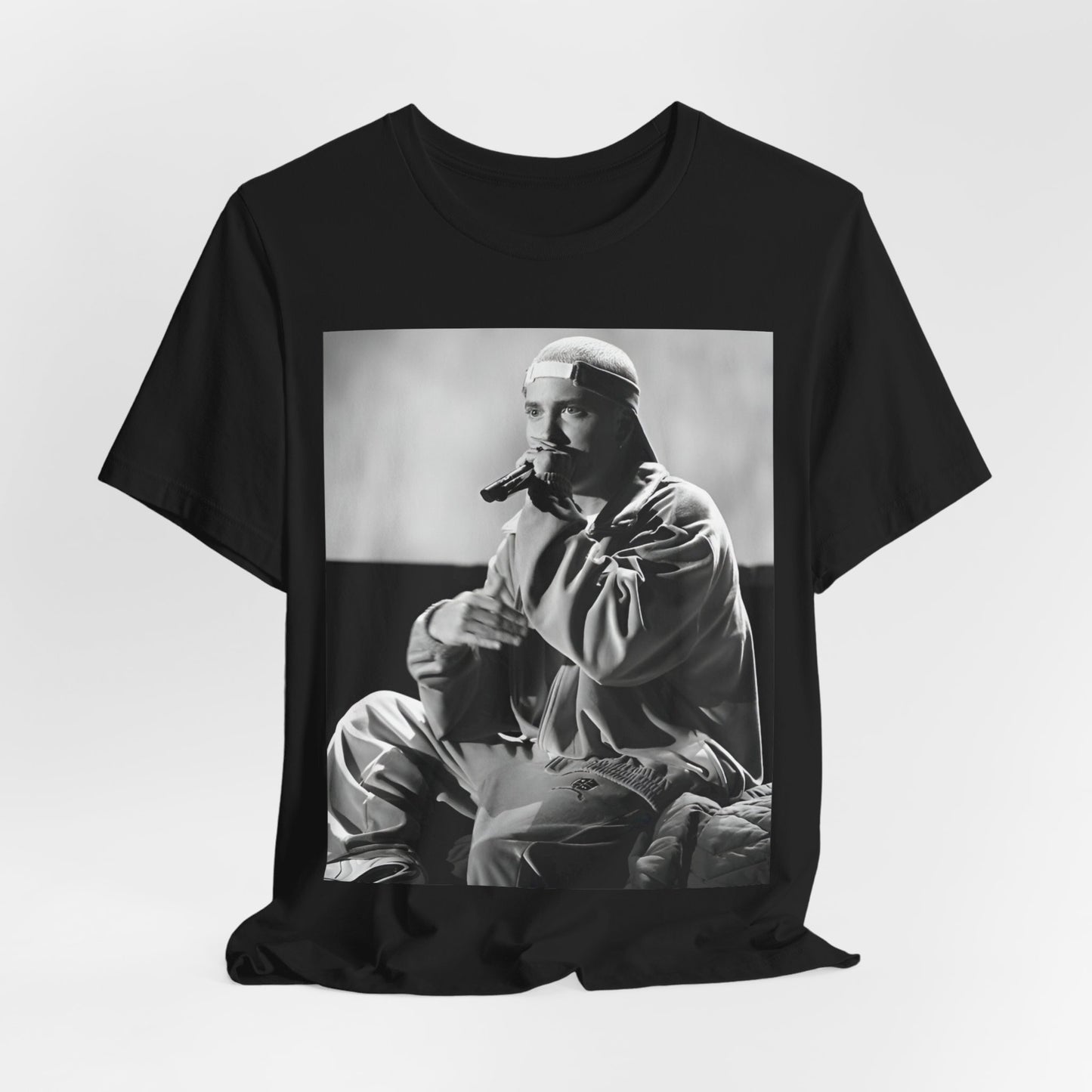 A black graphic t-shirt featuring a black and white graphic of Eminem as a 'Rap Messiah'.