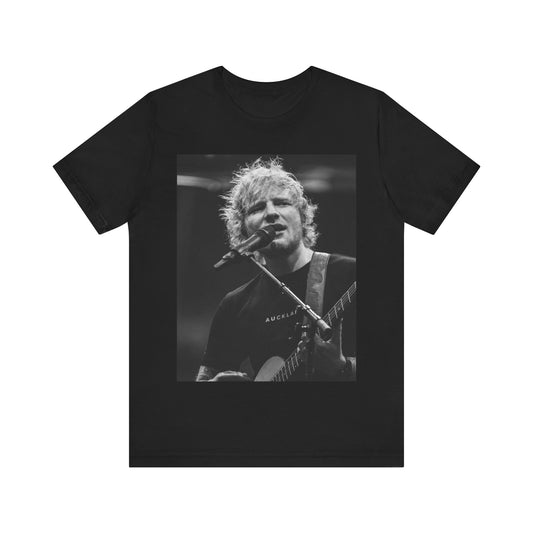 A black graphic t-shirt featuring a black and white photo of Ed Sheeran performing live.