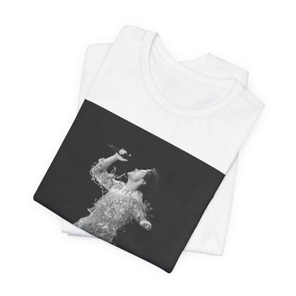 A black graphic t-shirt featuring a boxy pop aesthetic graphic of Harry Styles.