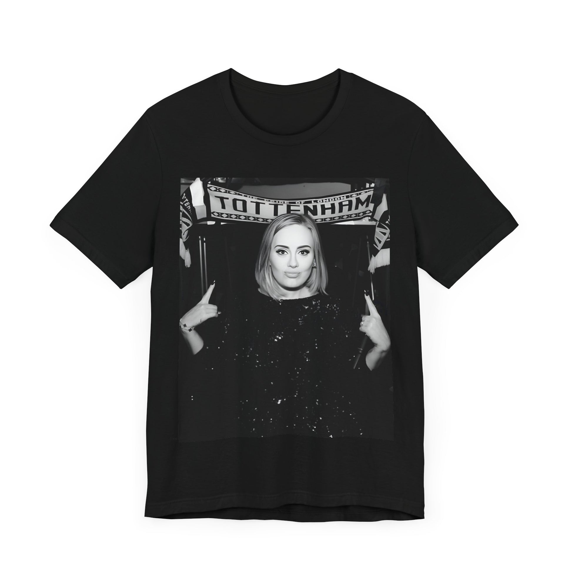 A black graphic t-shirt featuring a photo of Adele in a casual setting, surrounded by fans at a Tottenham event, showing her smiling or interacting.