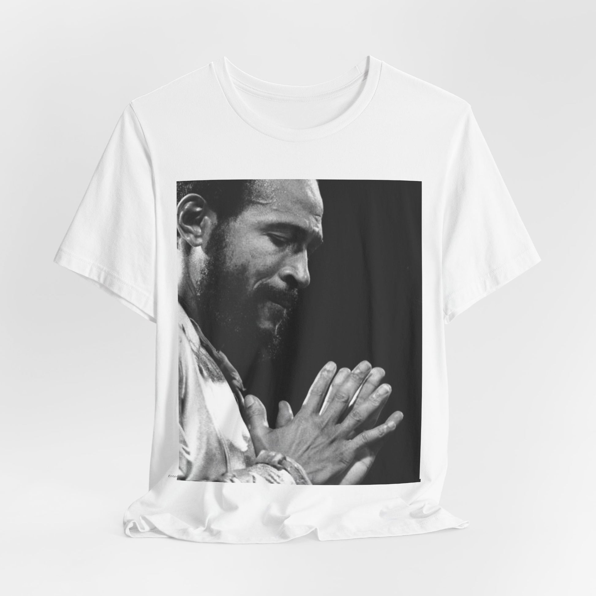 A black graphic t-shirt featuring a 70s graphic of Marvin Gaye emphasizing his soulful voice.
