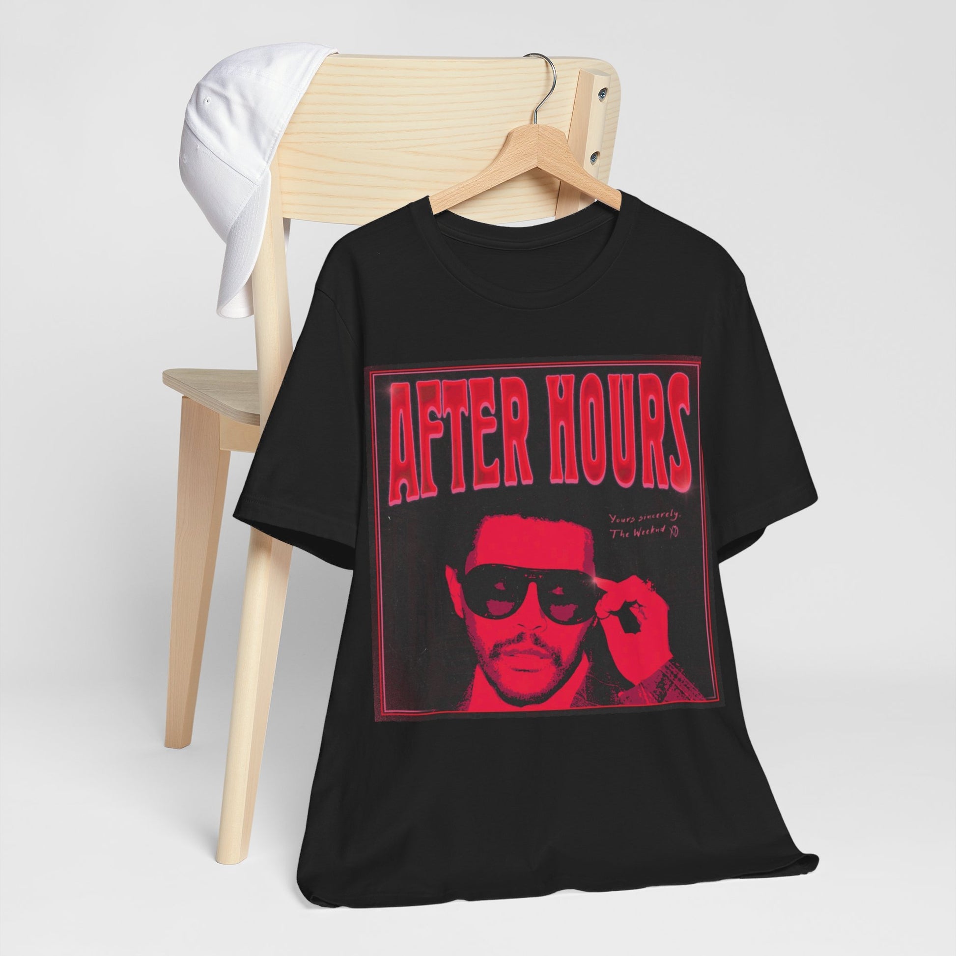 A black graphic t-shirt featuring a retro graphic related to The Weeknd's 'After Hours' album.