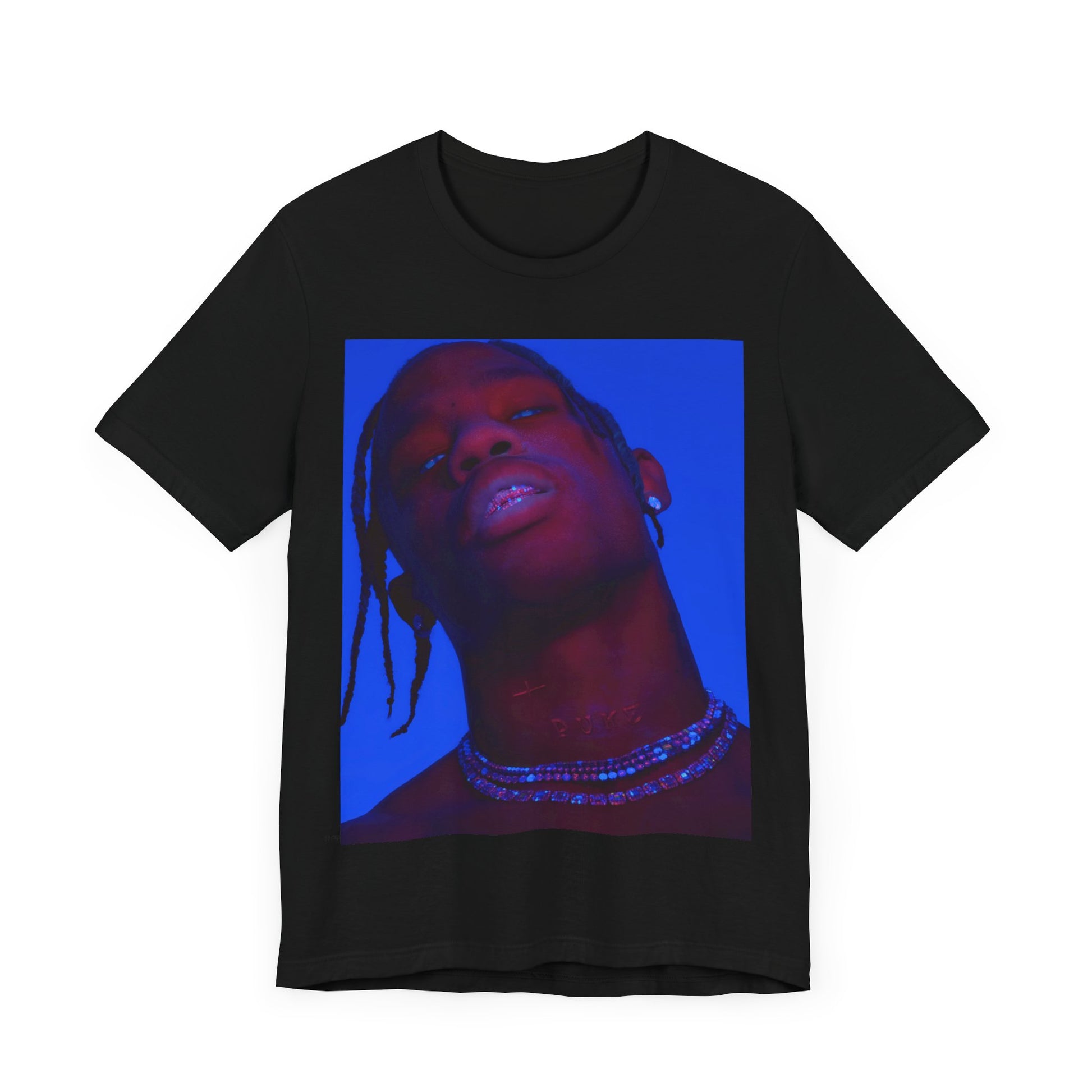 A black graphic t-shirt featuring a bold graphic of Travis Scott as a rap superstar.