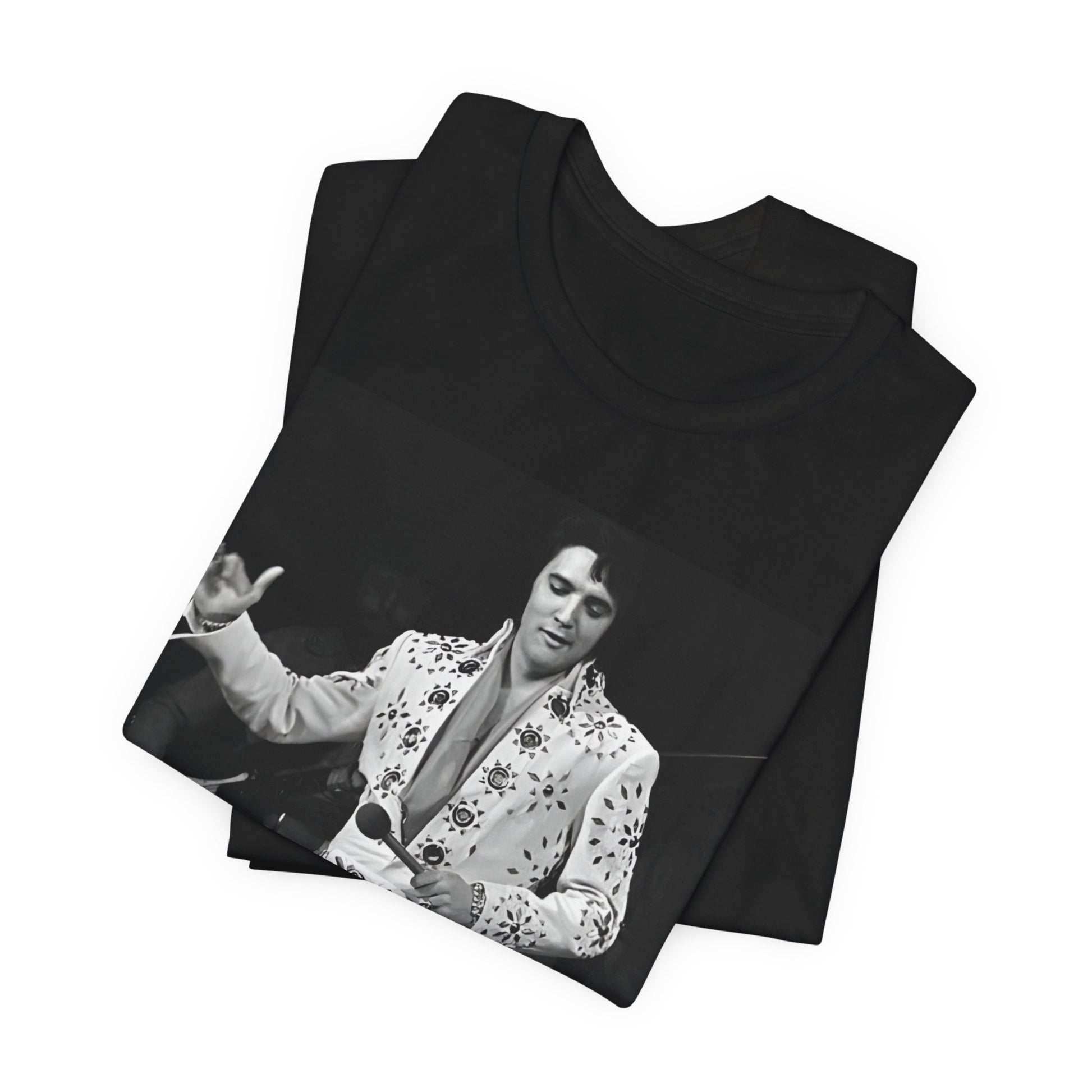 A black graphic t-shirt featuring a stylized graphic of Elvis Presley as The King of Rock 'n' Roll.