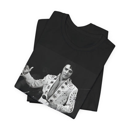 A black graphic t-shirt featuring a stylized graphic of Elvis Presley as The King of Rock 'n' Roll.