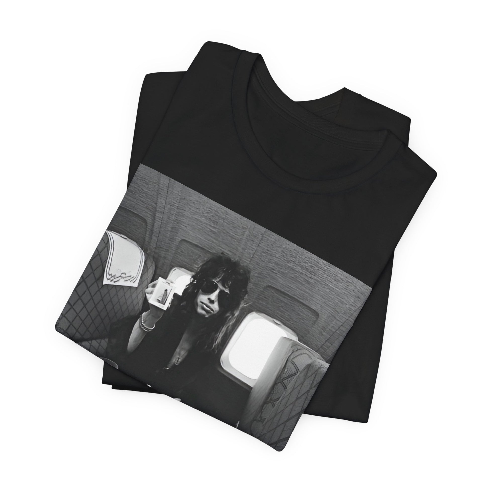 A black graphic t-shirt featuring a vintage 70s-style illustration of an airplane with Aerosmith branding, representing their tour plane from that era.
