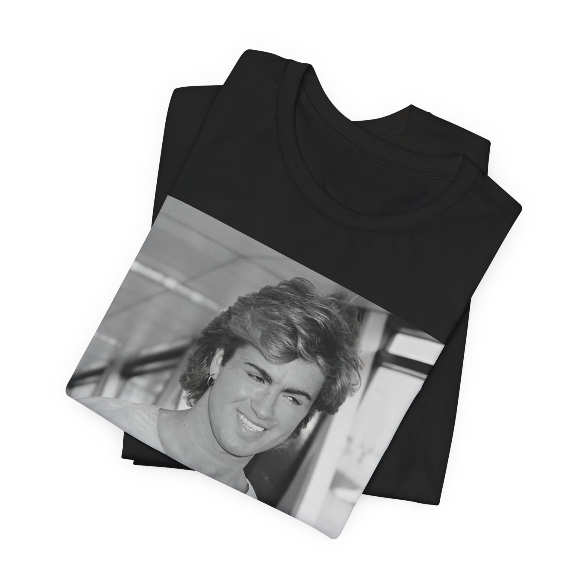 A black graphic t-shirt featuring an 80s black and white vintage photo or graphic of George Michael.