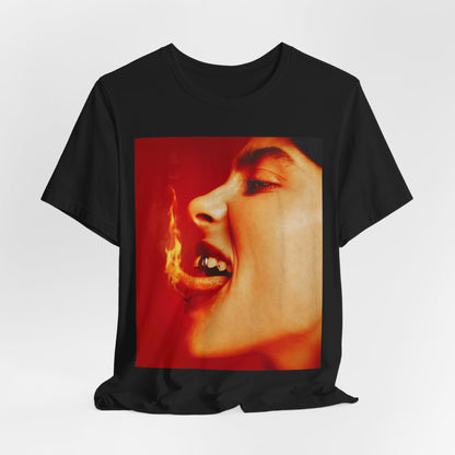 A close-up, red-toned photo of a face in profile with its mouth open and a live flame on the tongue, printed on a graphic t-shirt.