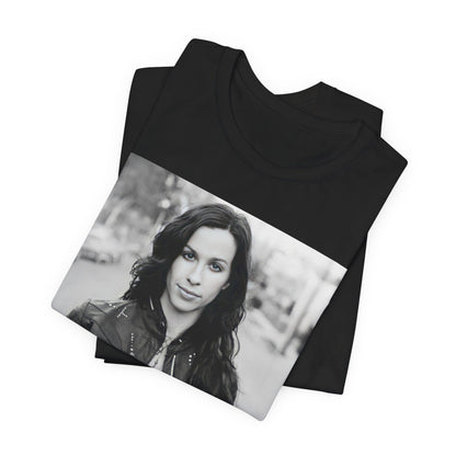A black graphic t-shirt featuring a black and white photo of Alanis Morissette from 1998, showing her with a poised or thoughtful expression.