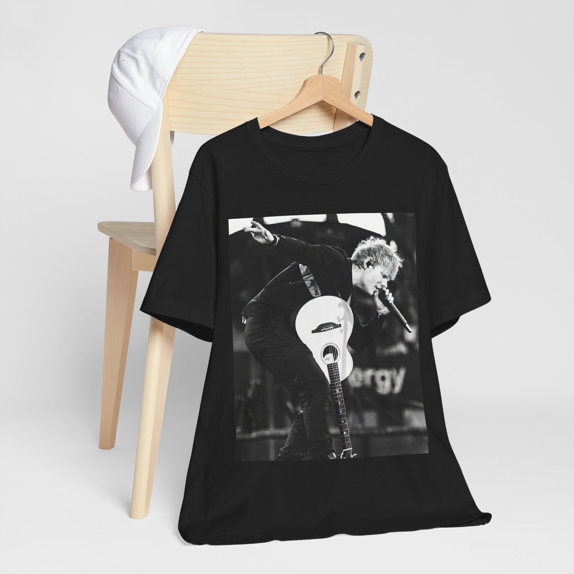 A black graphic t-shirt featuring a vintage graphic of Ed Sheeran performing live.