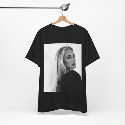 A black graphic t-shirt featuring a black and white, monochromatic portrait of Adele, showing her with a serene or thoughtful expression.