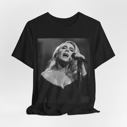 A black graphic t-shirt featuring a dynamic image of Adele performing on stage, with lighting effects, likely from her 'One Night Only' concert special.