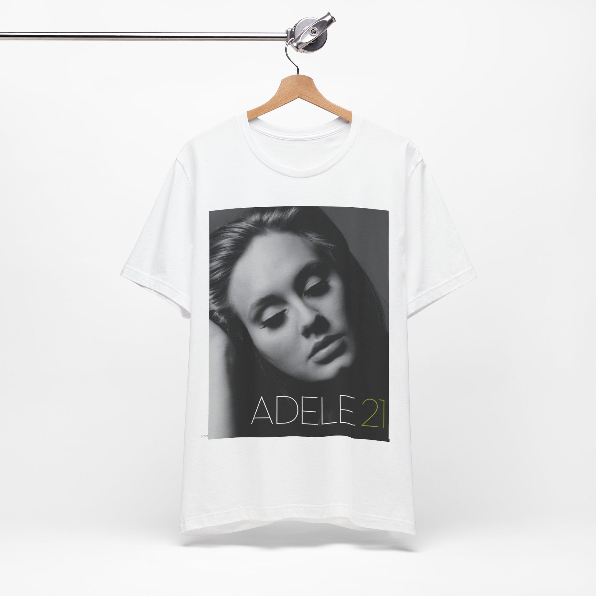 A black graphic t-shirt featuring the album cover art for Adele's '21' album, showing a close-up portrait of her with a contemplative expression.