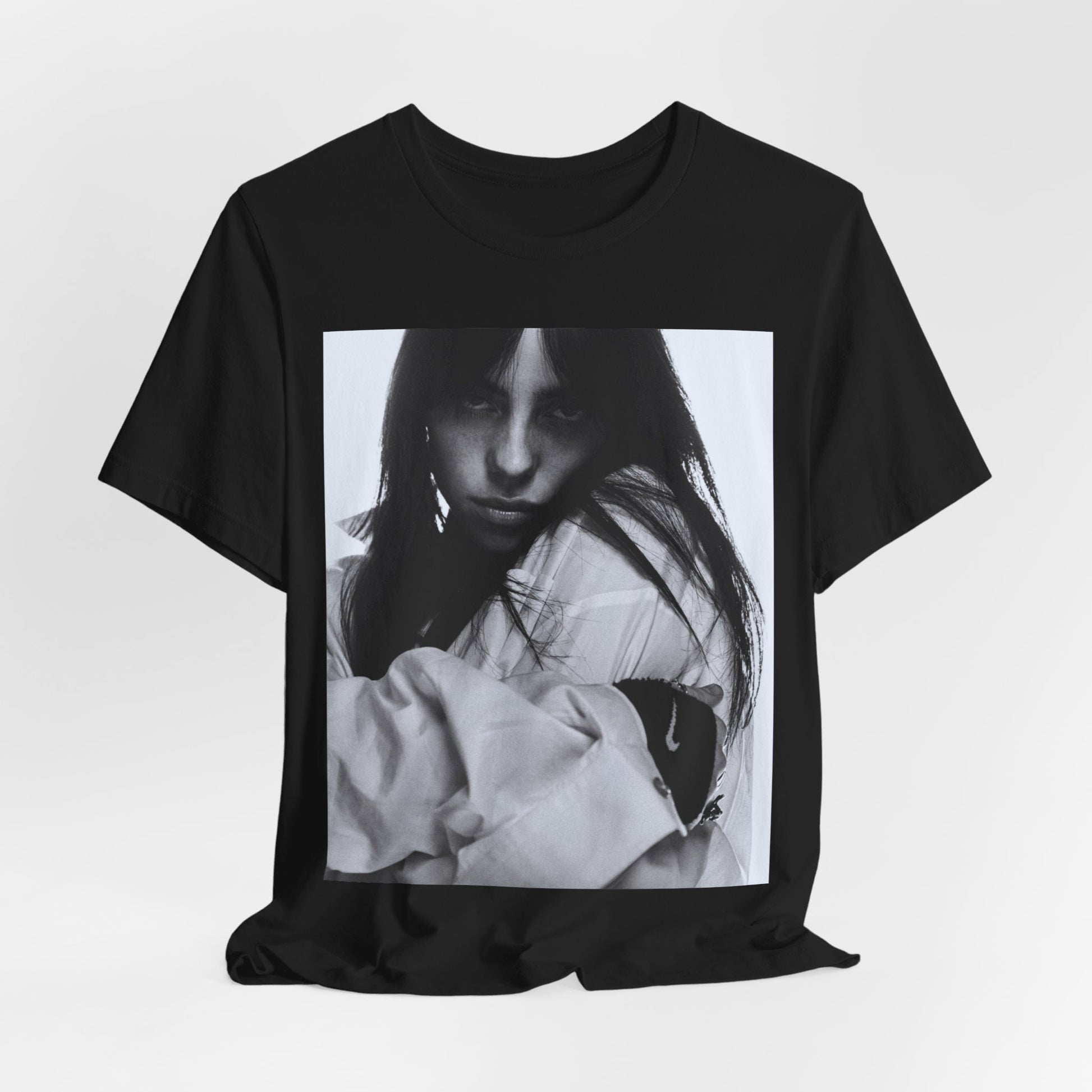 Billie Eilish posing in her signature oversized designer streetwear, printed on a graphic t-shirt.