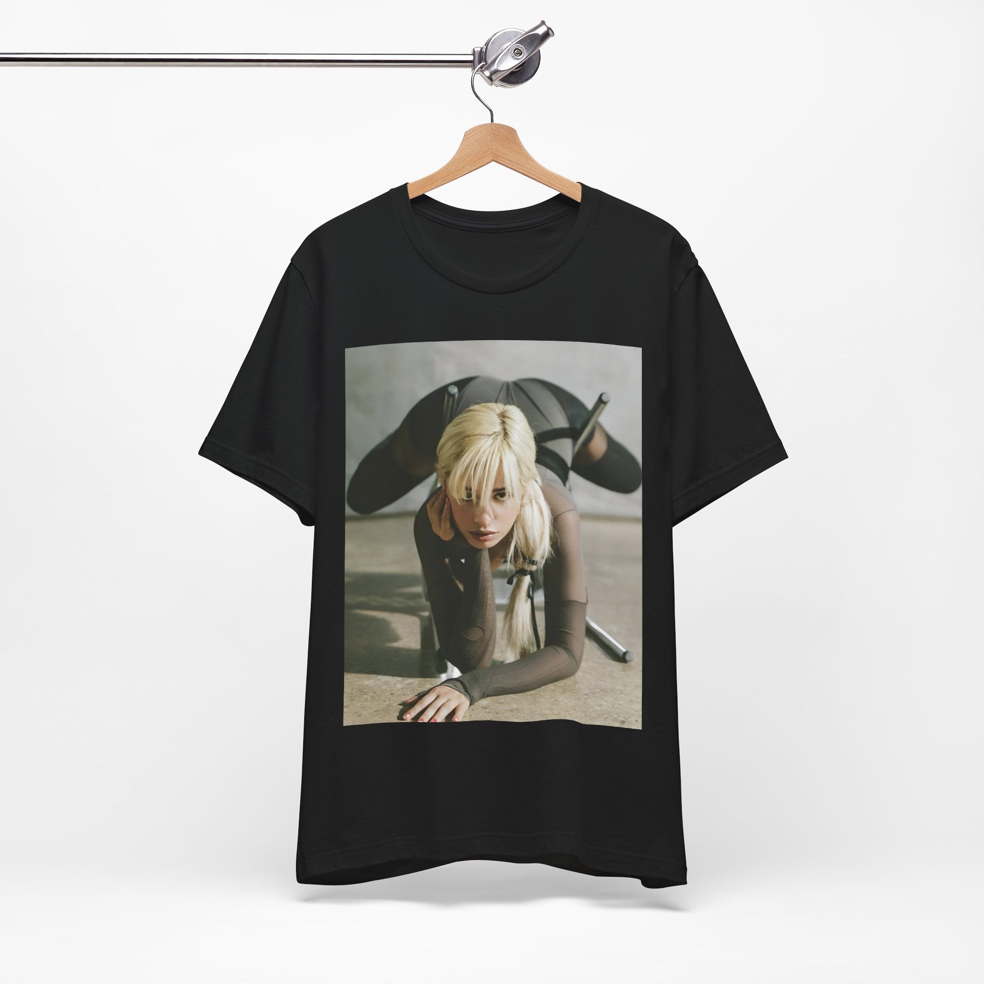 A black graphic t-shirt featuring a vintage-style graphic of Camila Cabello, possibly with a crown or 'Pop Queen' title.