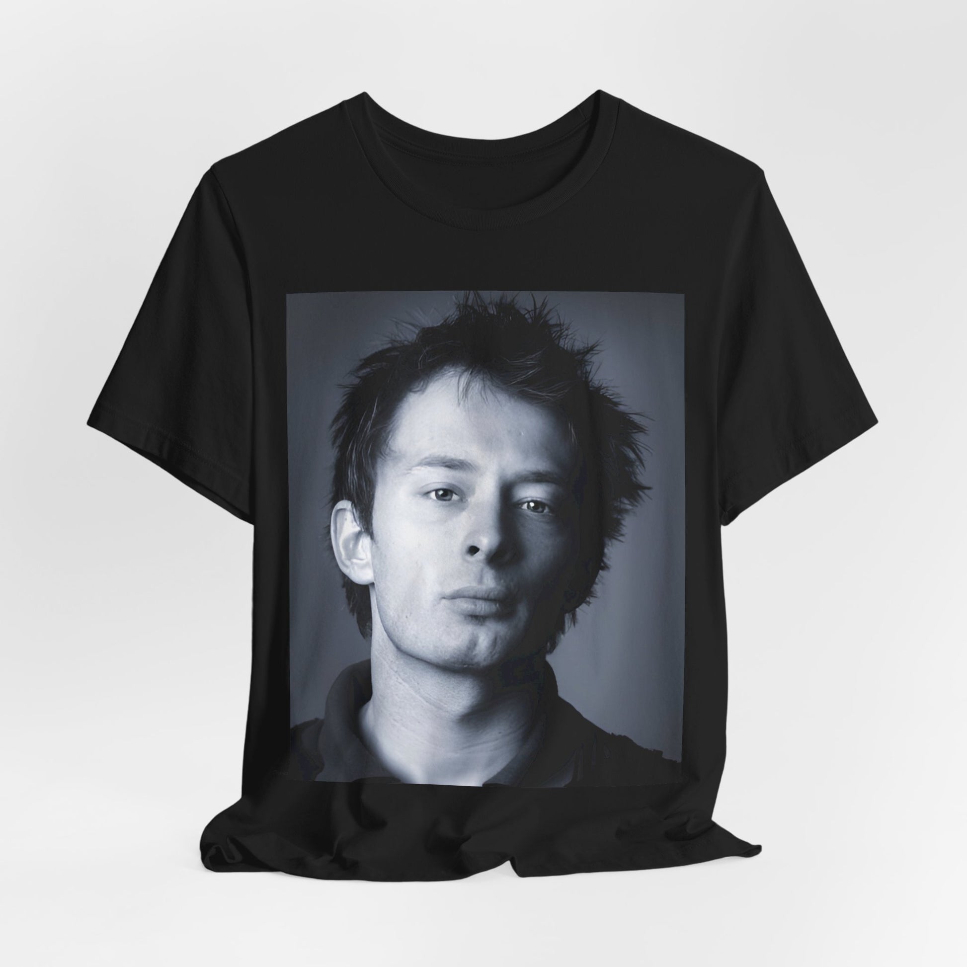 A black graphic t-shirt featuring an enigmatic graphic of Thom Yorke from Radiohead as a frontman.