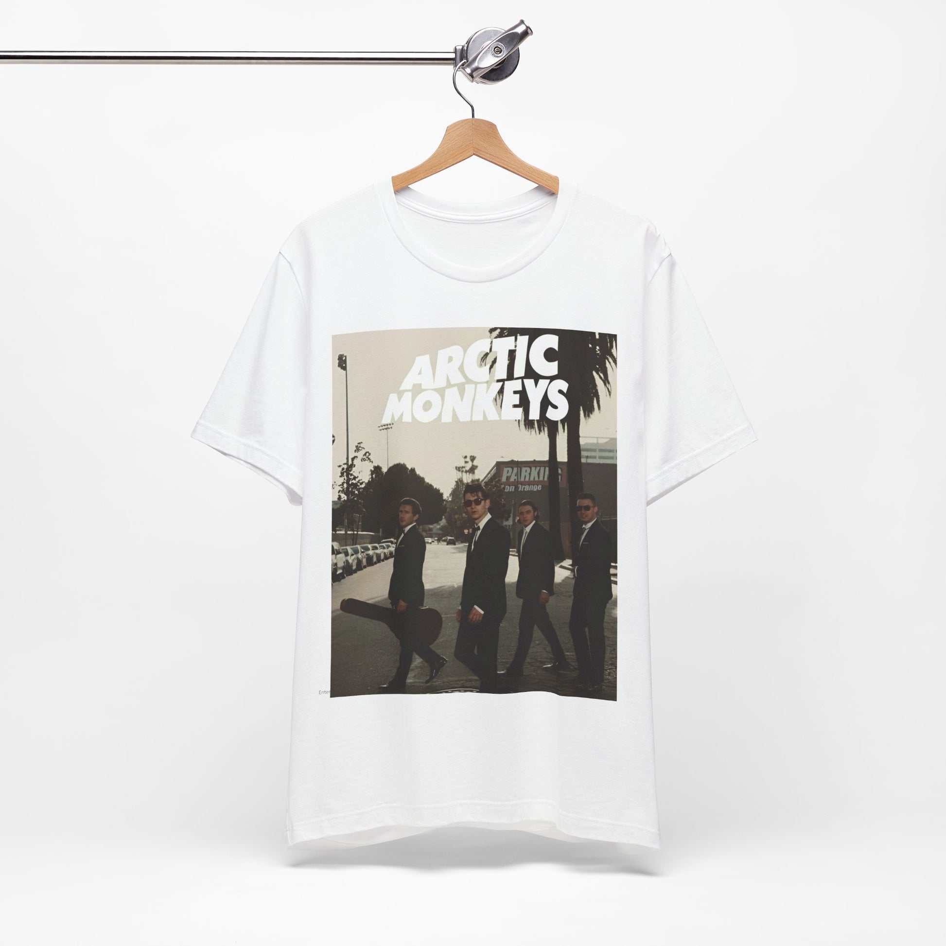 A black graphic t-shirt featuring Arctic Monkeys in a pose or setting similar to the iconic 'Abbey Road' album cover.