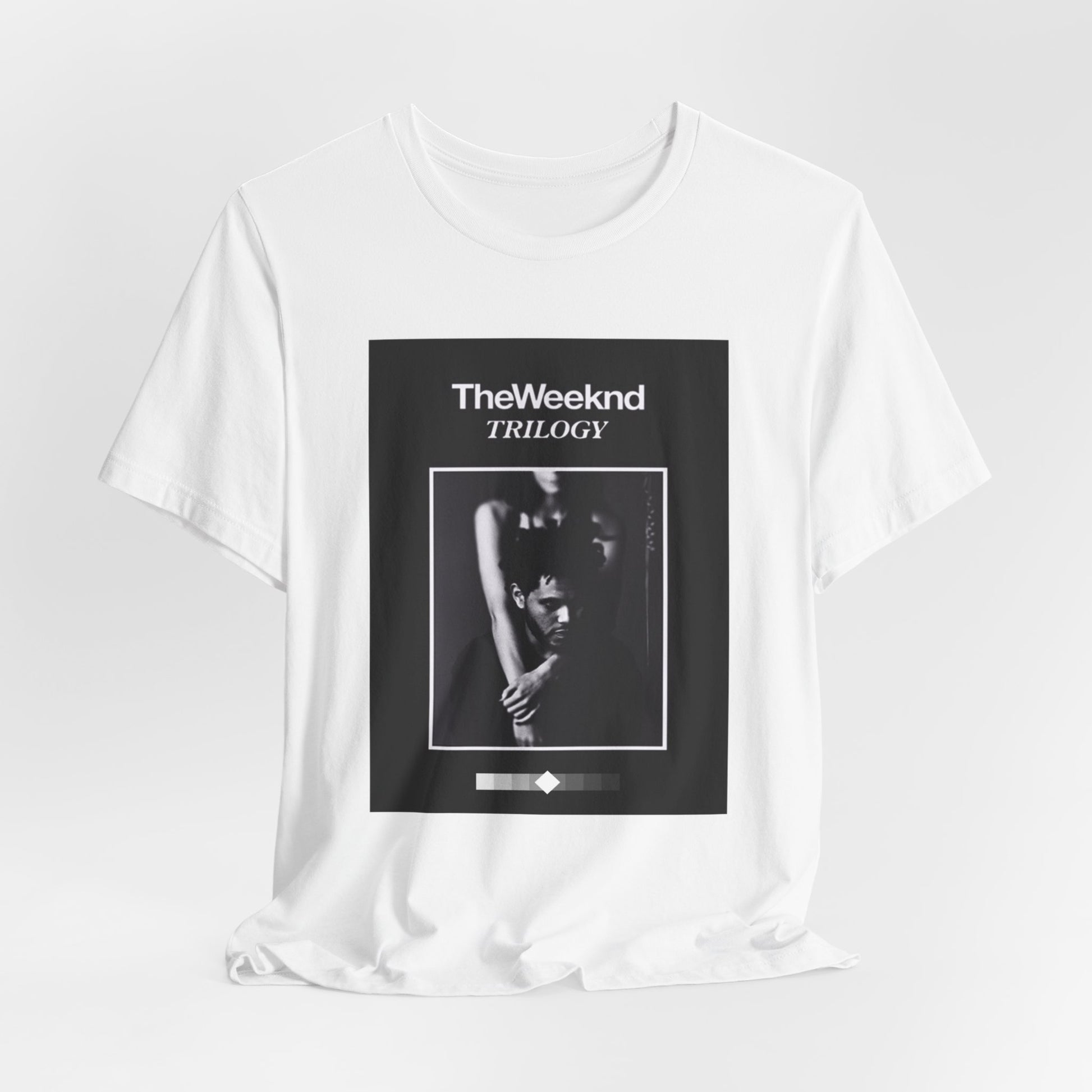 A black graphic t-shirt featuring a graphic related to The Weeknd's 'Trilogy' album.