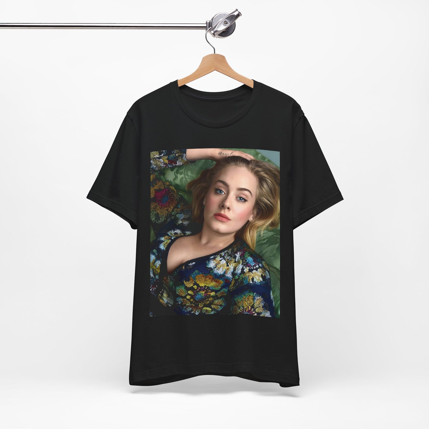 A black graphic t-shirt featuring a photo of Adele, possibly with floral elements or a floral background, showing a serene or contemplative expression.