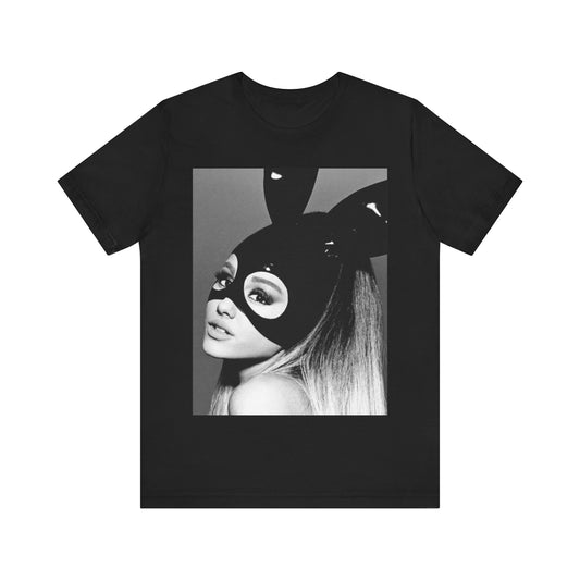 A black graphic t-shirt featuring a black and white graphic inspired by Ariana Grande's 'Dangerous Woman' album or era, possibly with her iconic mask or pose.