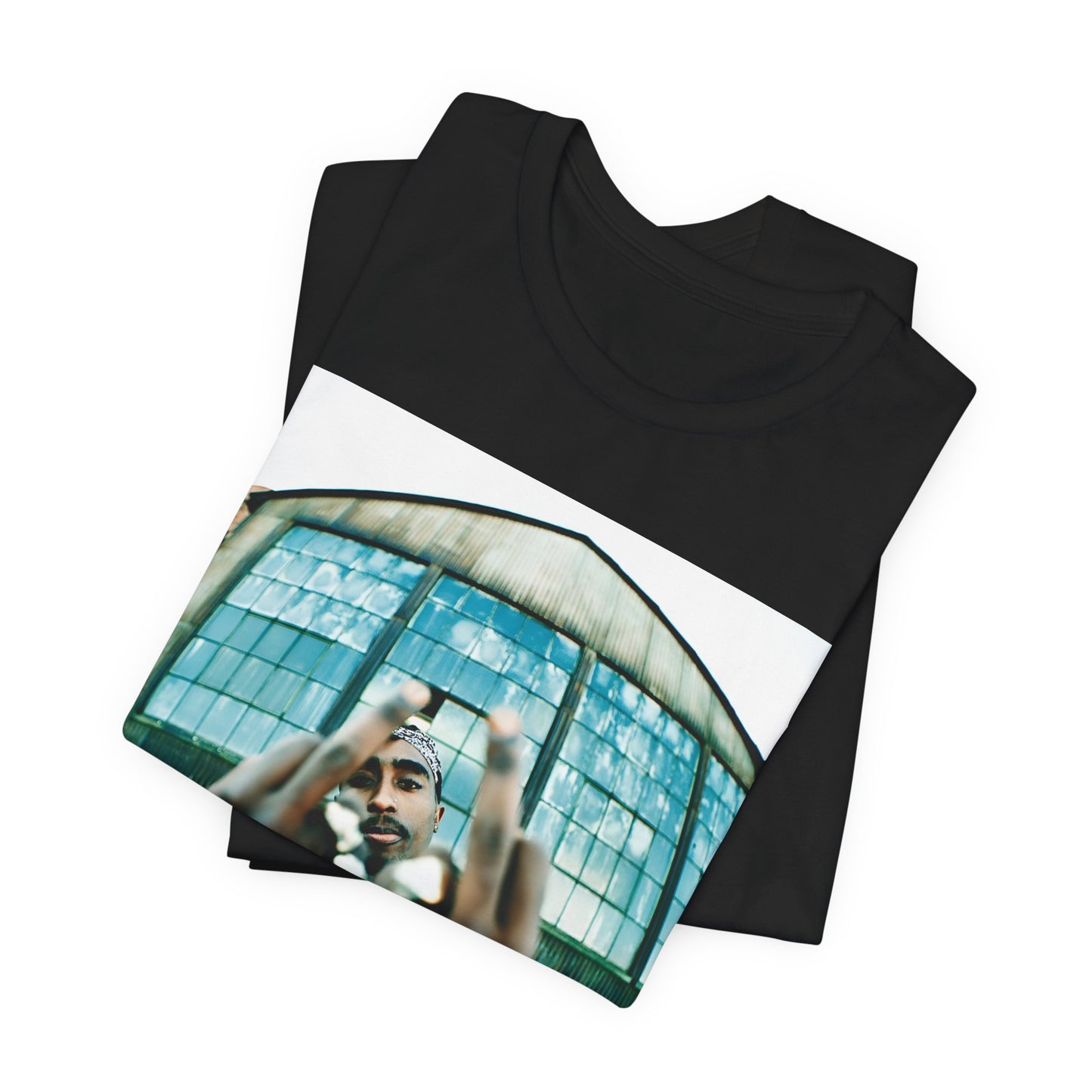A black graphic t-shirt featuring a graphic of Tupac giving the middle finger.