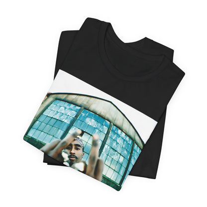 A black graphic t-shirt featuring a graphic of Tupac giving the middle finger.