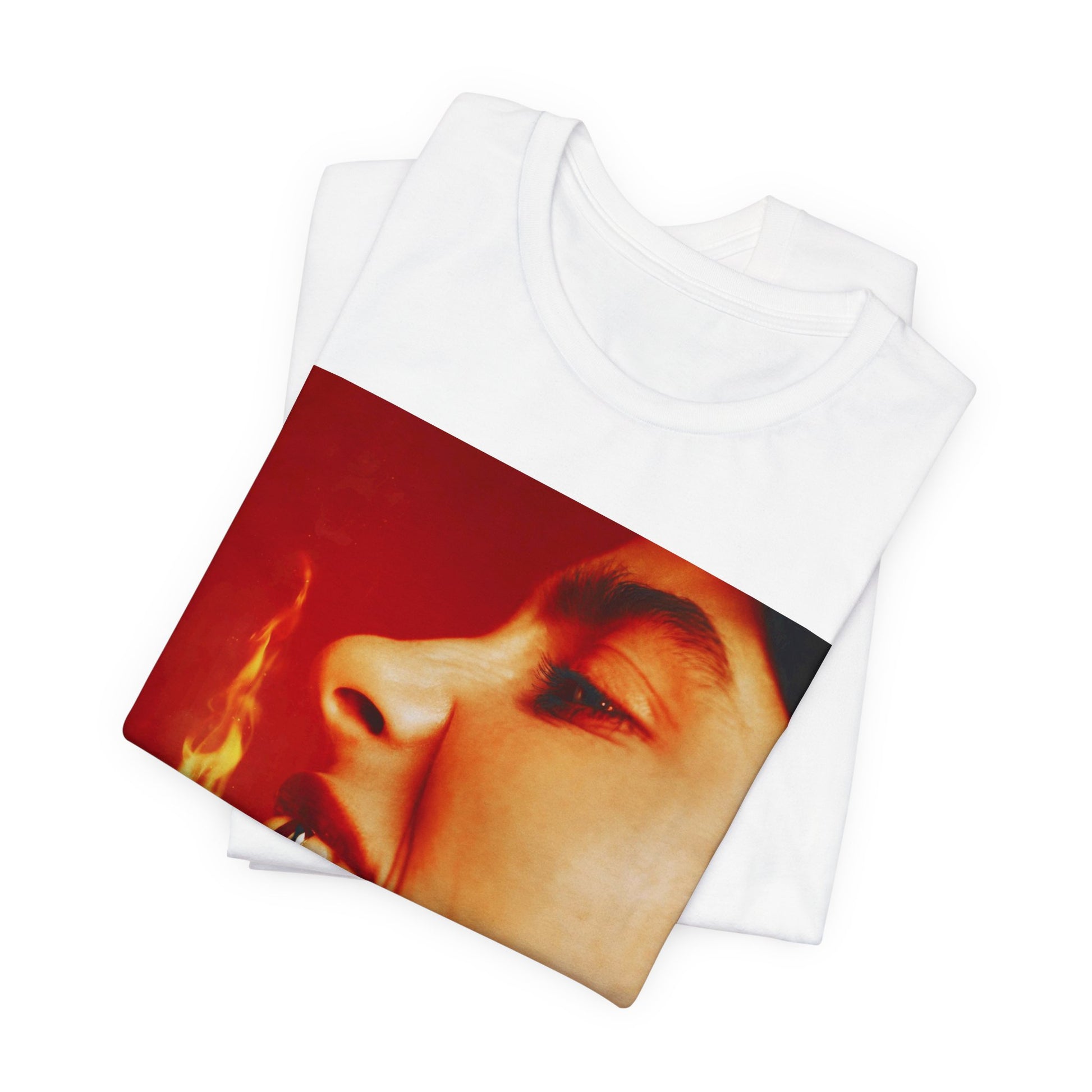 A close-up, red-toned photo of a face in profile with its mouth open and a live flame on the tongue, printed on a graphic t-shirt.