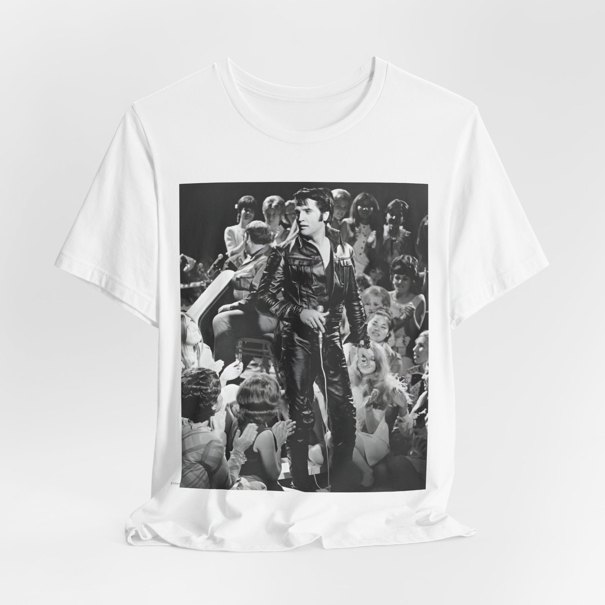 A black graphic t-shirt featuring a vintage black and white photo or graphic of Elvis Presley performing live on stage.