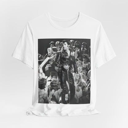 A black graphic t-shirt featuring a vintage black and white photo or graphic of Elvis Presley performing live on stage.