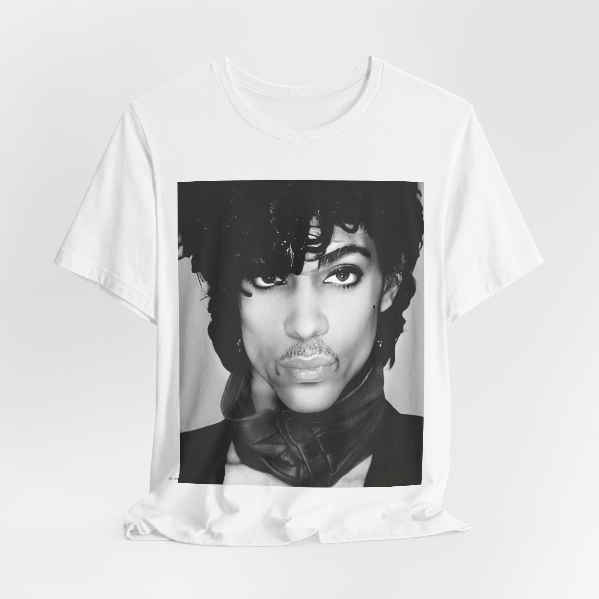 A black graphic t-shirt featuring a black and white photo portrait of Prince.
