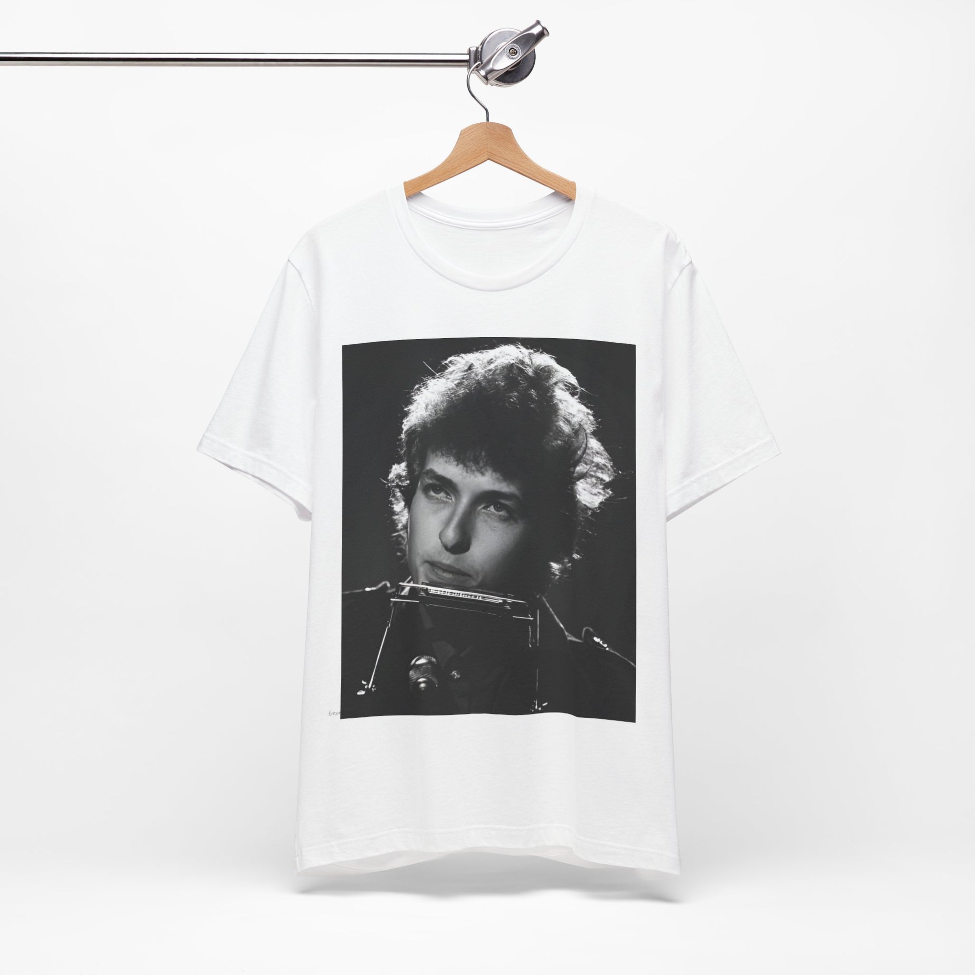 A black graphic t-shirt featuring a graphic of Bob Dylan from the 60s playing his harmonica.