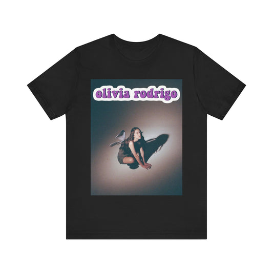 A black graphic t-shirt featuring a cool indie pop princess graphic of Olivia Rodrigo.