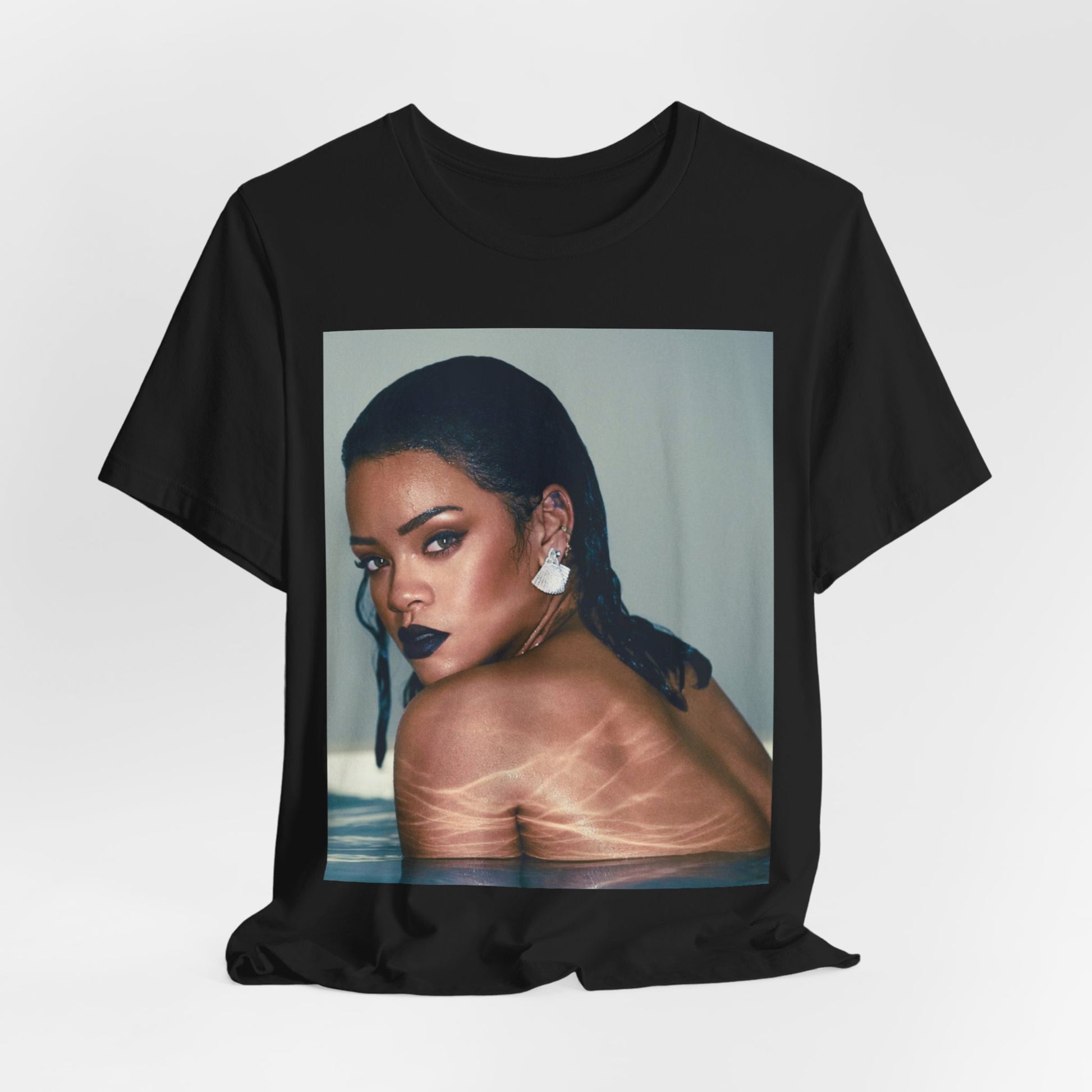 A black graphic t-shirt featuring a vintage pop icon graphic of Rihanna.