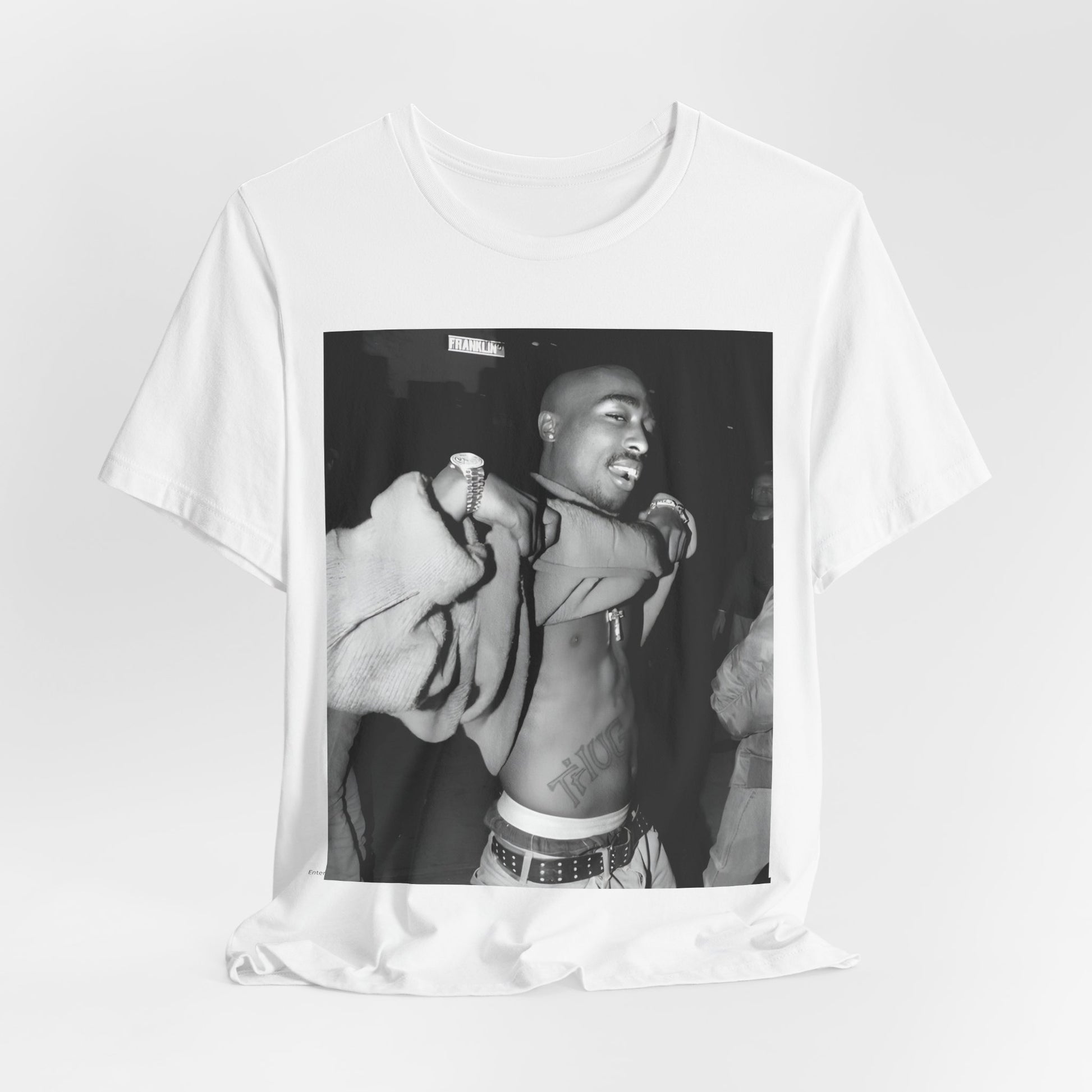 A black graphic t-shirt featuring a vintage hip hop icon graphic of Tupac.