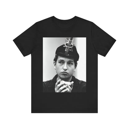 A black graphic t-shirt featuring a graphic of Bob Dylan in an acoustic session setting, possibly with his guitar.