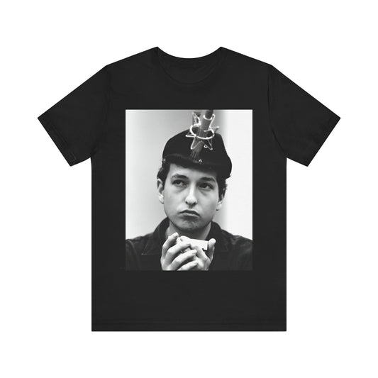 A black graphic t-shirt featuring a graphic of Bob Dylan in an acoustic session setting, possibly with his guitar.